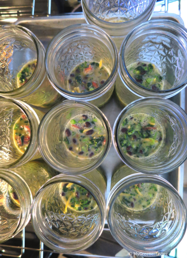raw eggs and veggies in mason jars on a ban ready to bake
