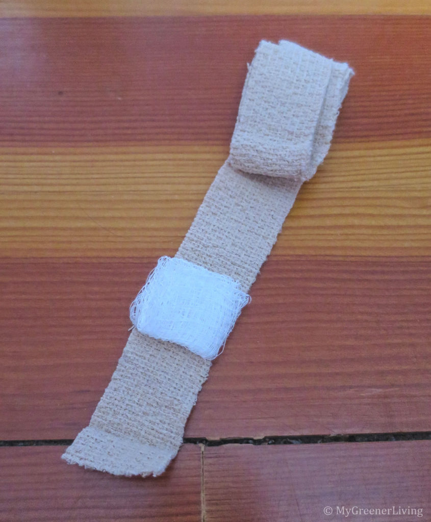 1" wide strip of self-adhesive bandage with folded piece of gauze