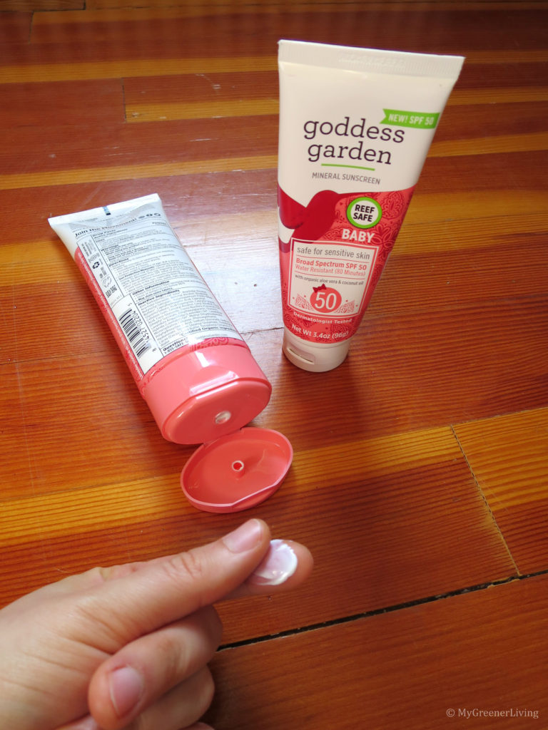Goddess Garden Baby SPF 50 Sunscreen lotion rubbed between finger and thumb to show consistency