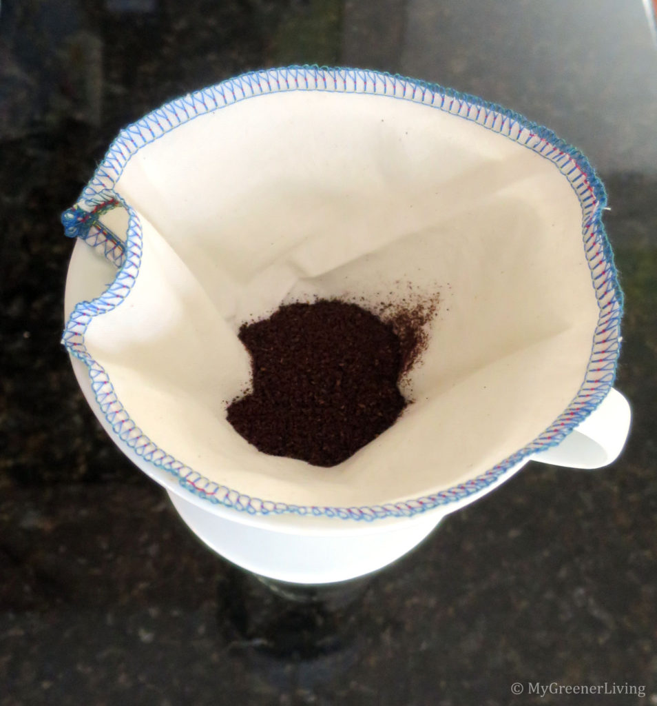 homemade cotton coffee filter in ceramic drip coffee cone with coffee