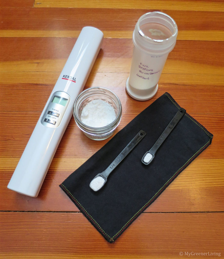 three different night guard (mouth guard) cleaners - UV sanitizing wand, sodium percarbonate, and cleaning mixture, plus measuring spoons with the cleaning powders